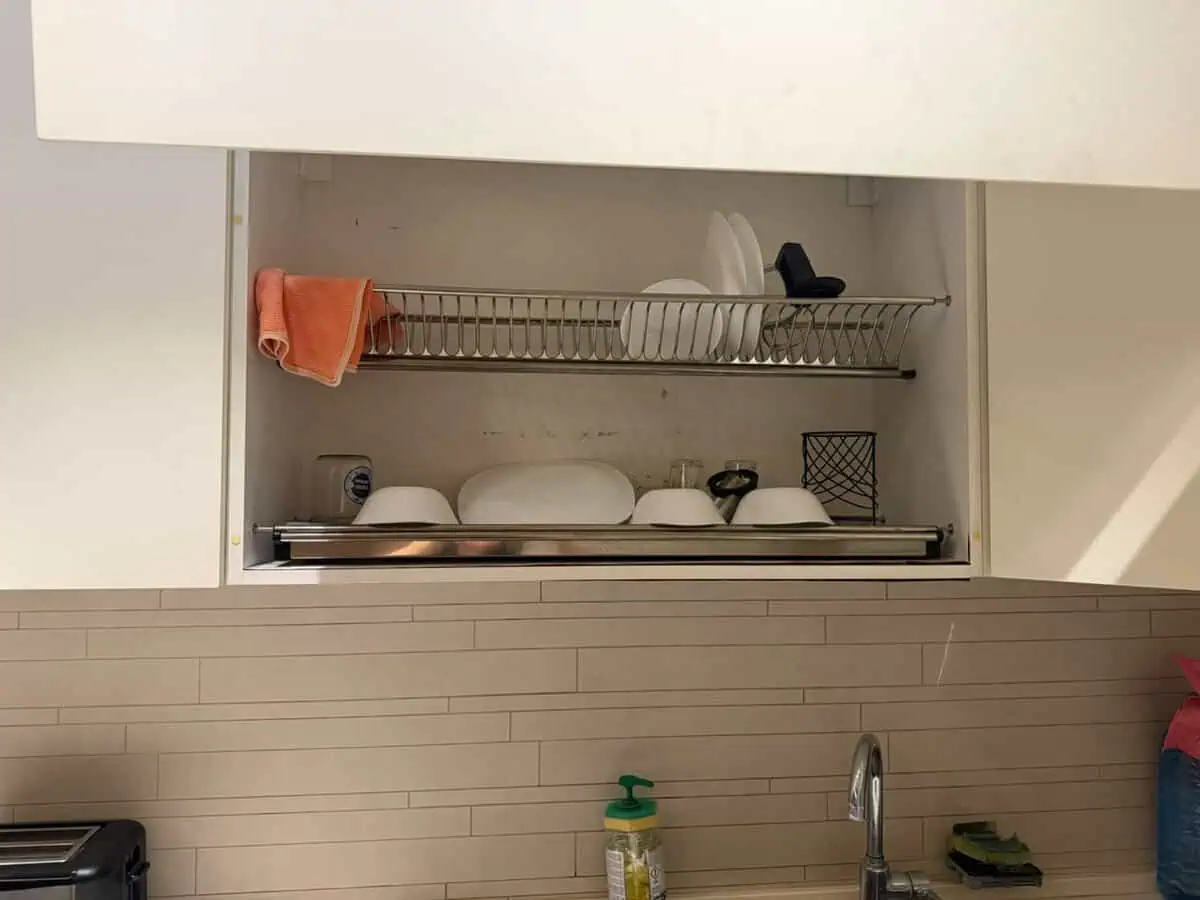 Master documents dish rack condition in a Tbilisi kitchen
