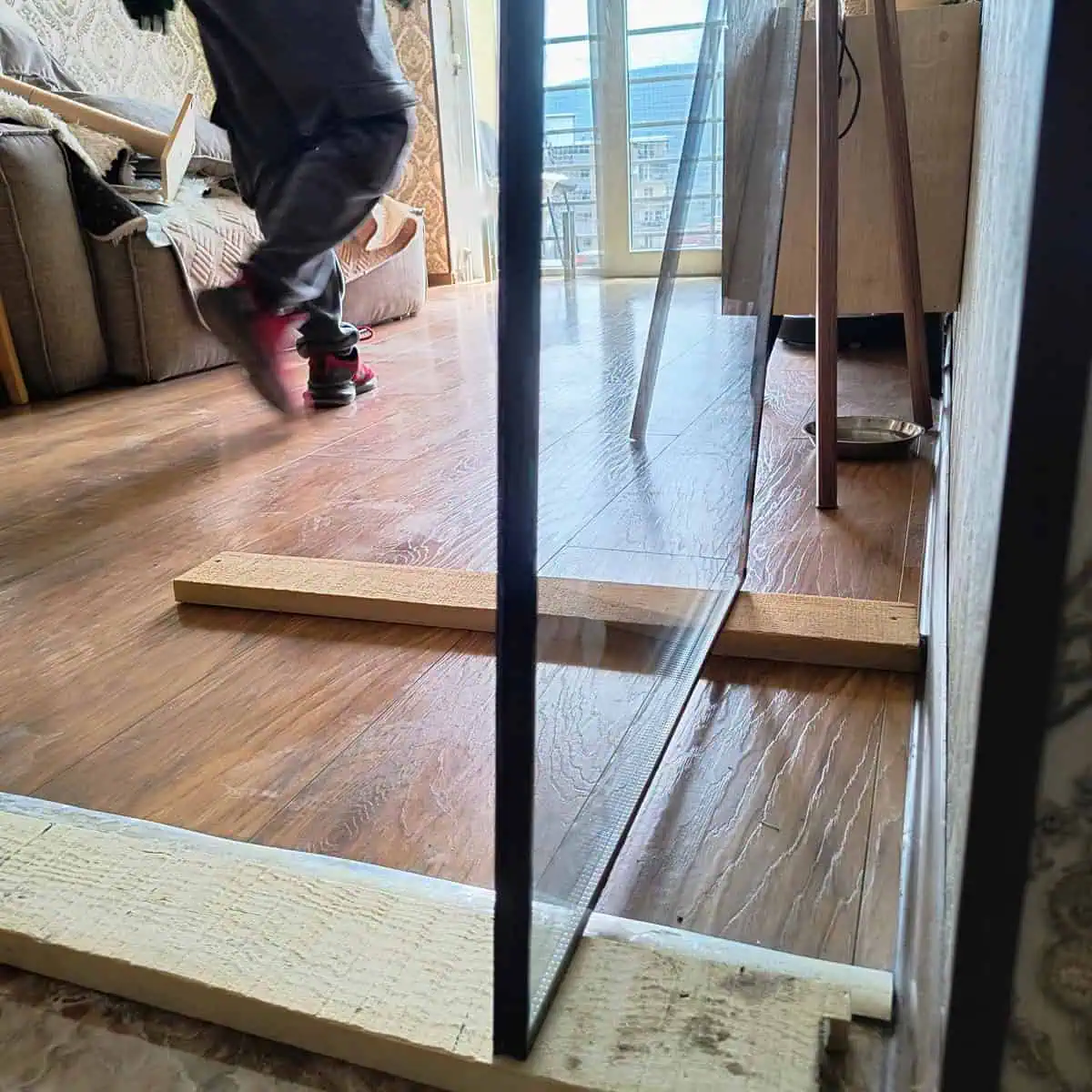 Double-glazed unit in timber protective packaging on the floor before installation in Tbilisi